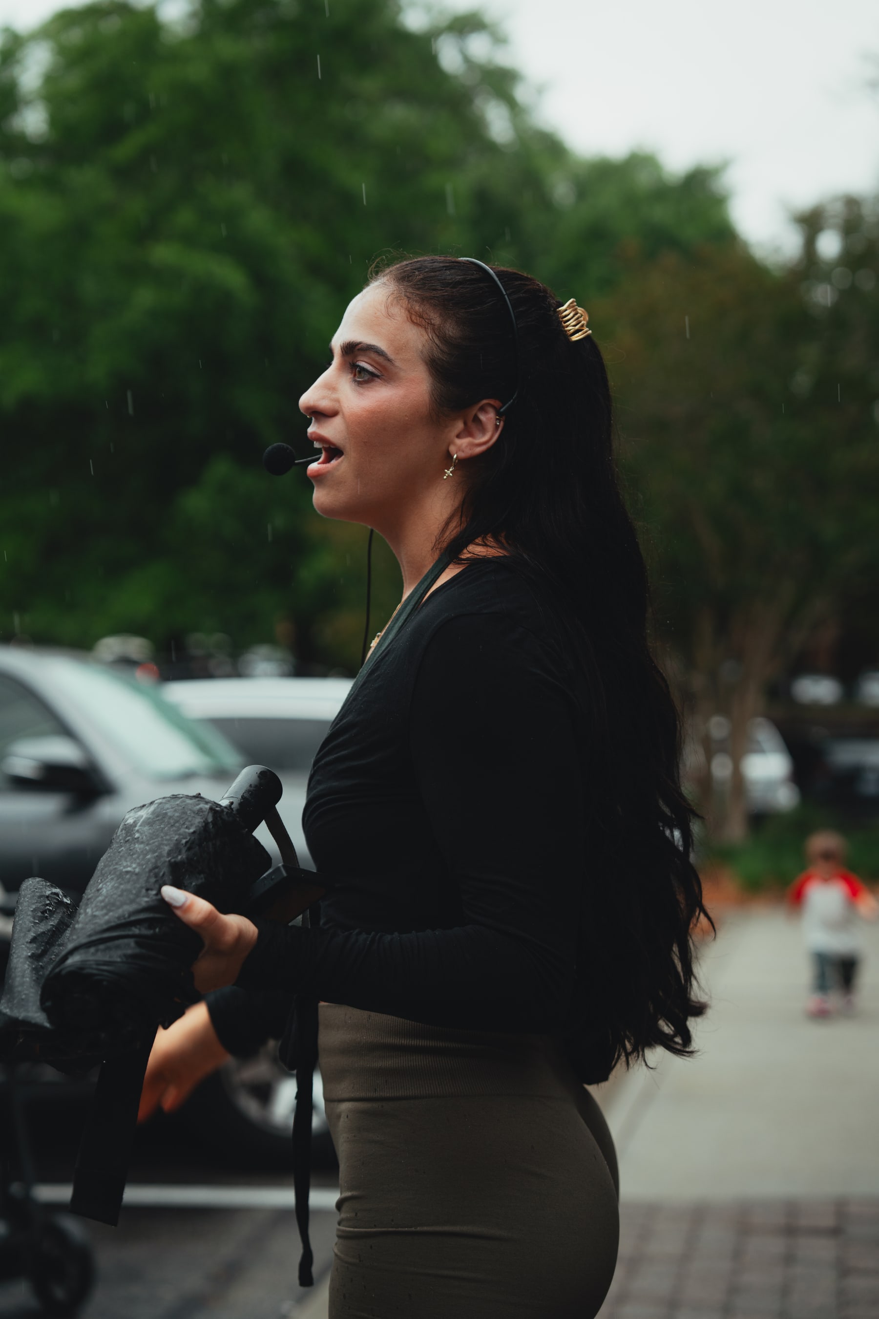 Brooke Pereira coaching at Babes & Barbells, headset mic, mid-speech, natural light